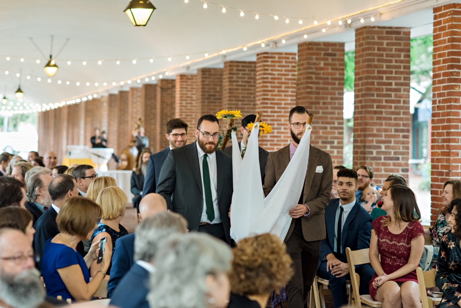 Four men carry the chuppah down the isle at this Philadelphia Shambles Wedding.